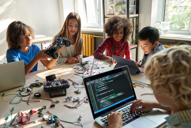 group of kids work on STEM activity