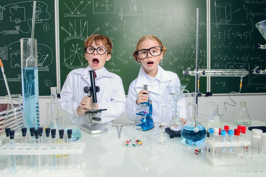 girl and boy Engineering experiments in a lab coat and safety goggles