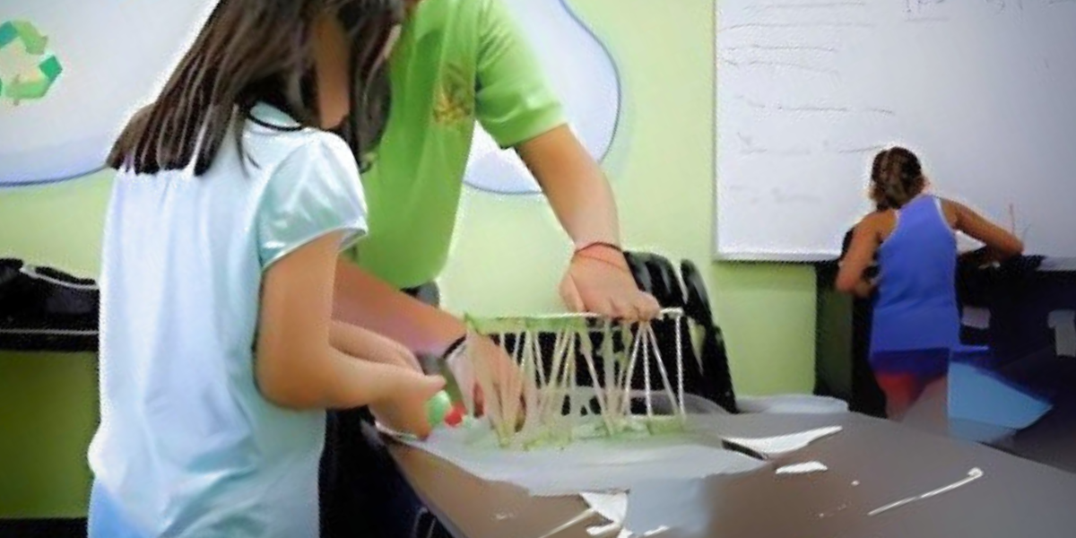 Students constructing a bridge as part of fun and educational science-based activities for kids and moms. This Mother's Day engineering project teaches children about structural design and construction principles while developing problem-solving and critical thinking skills.